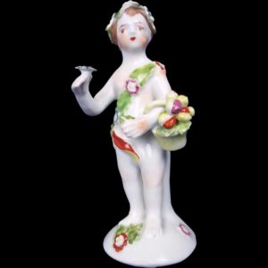 An English Bow Porcelain Figure Of A Putti Holding A Basket Of Fruit, c.1760