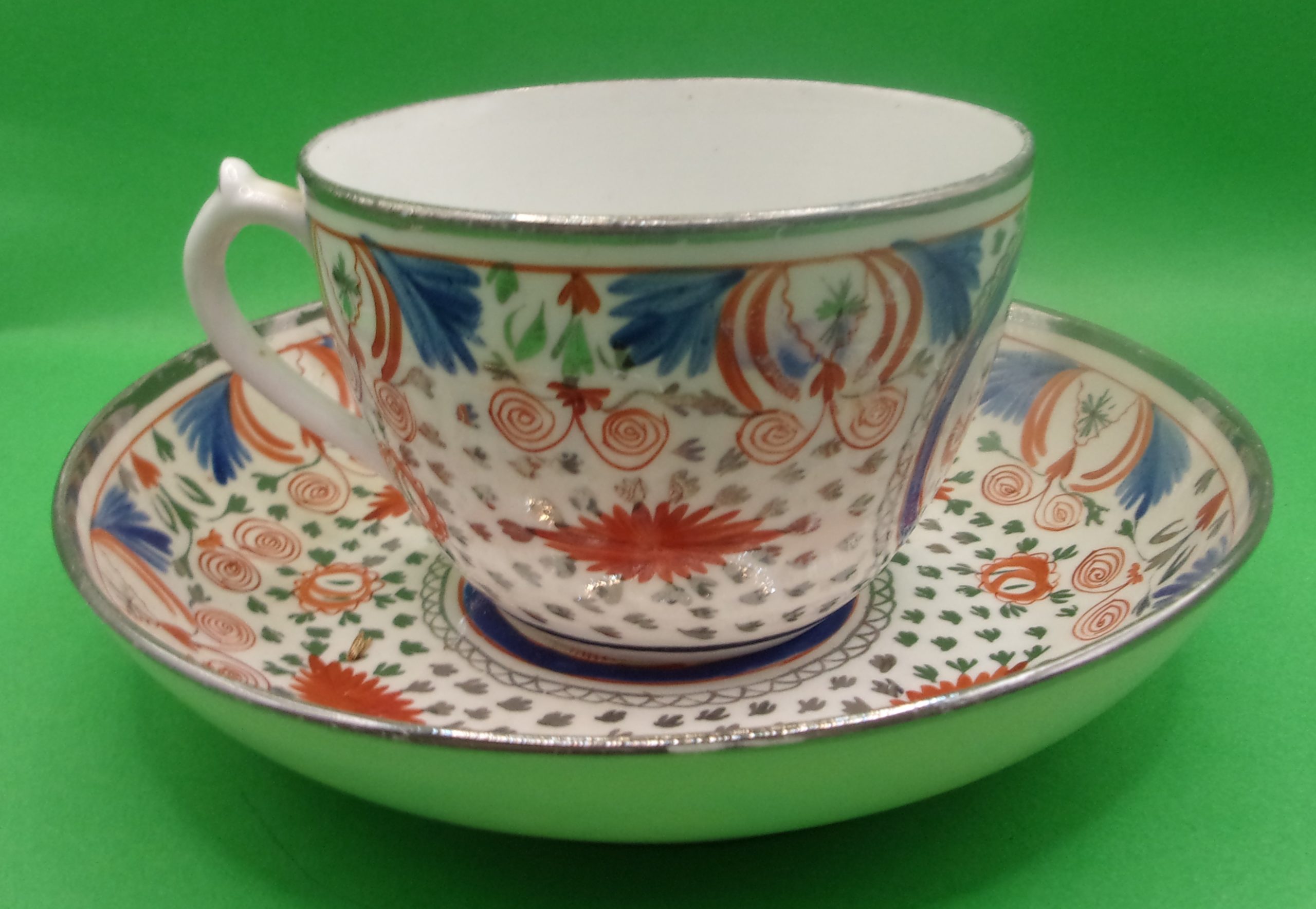 18th Century English Porcelain Teacup And Saucer In Polychrome Enamels With Silvering