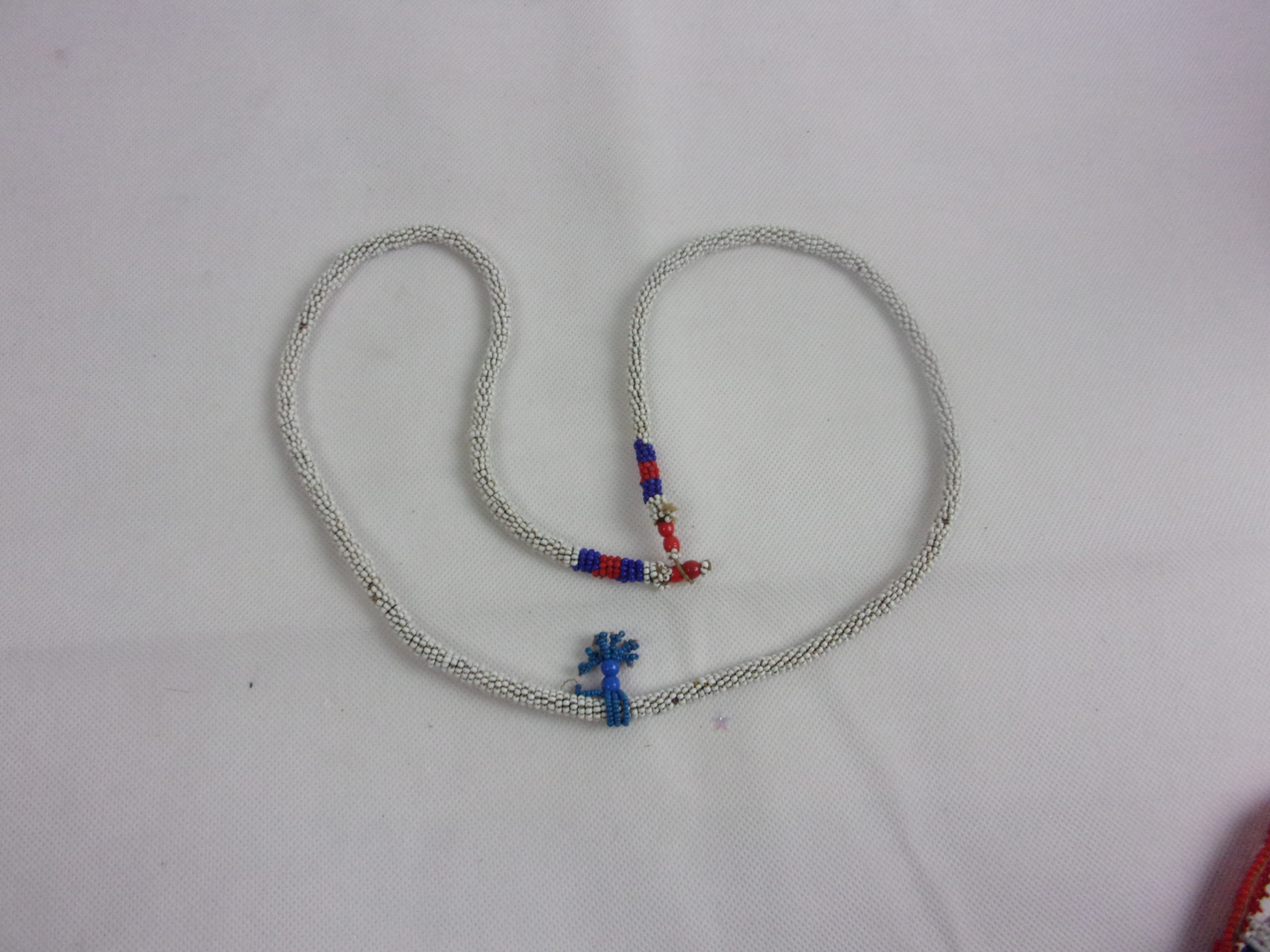 Zulu Tribal Rope Bead Work Necklace In White With A Blue Tassel
