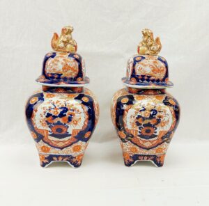 Pair Of Circa 1800 Footed Japanese Imari Vases With Lion Finials