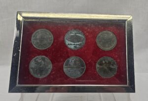 Cased Display Of 1970's RMS Queen Elizabeth Liner Coins