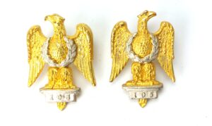 British, c.1930–1955, 1st Royal Dragoons 1902 Pattern Pair of Bi-Metal Collar Badges, Waterloo Eagle “105”